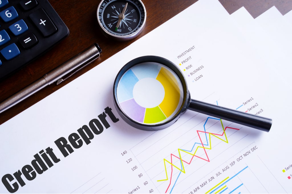Image of paper credit check with magnifying glass